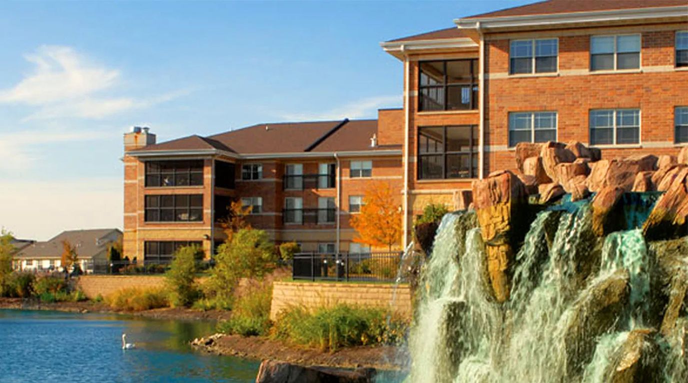 Exterior view of a nursing home near a waterfall