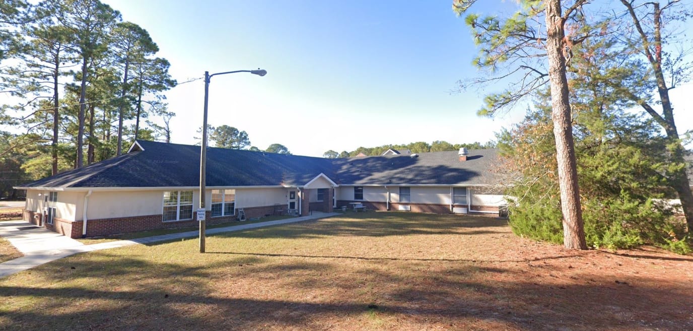 Exterior view of Liberty Commons facility surrounded by trees