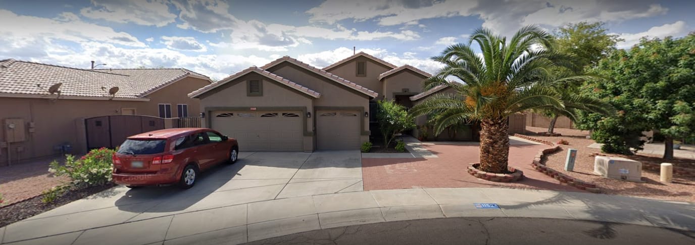 Exterior view of a residential building with palm trees