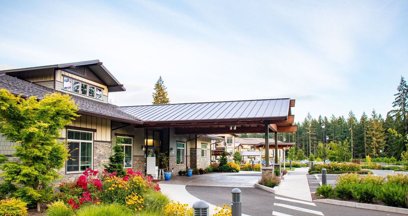 Exterior view of Garden Courte Memory Care with vibrant flowers