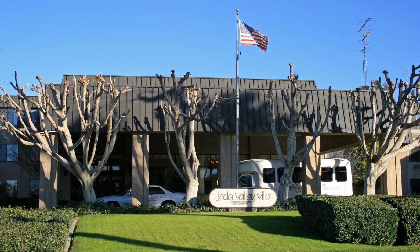 Exterior view of Linda Valley Villa with facility logo