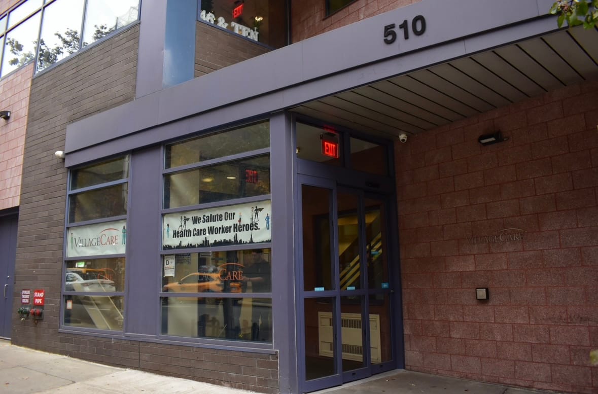 Entrance of VillageCare at 46 & Ten with a welcoming sign