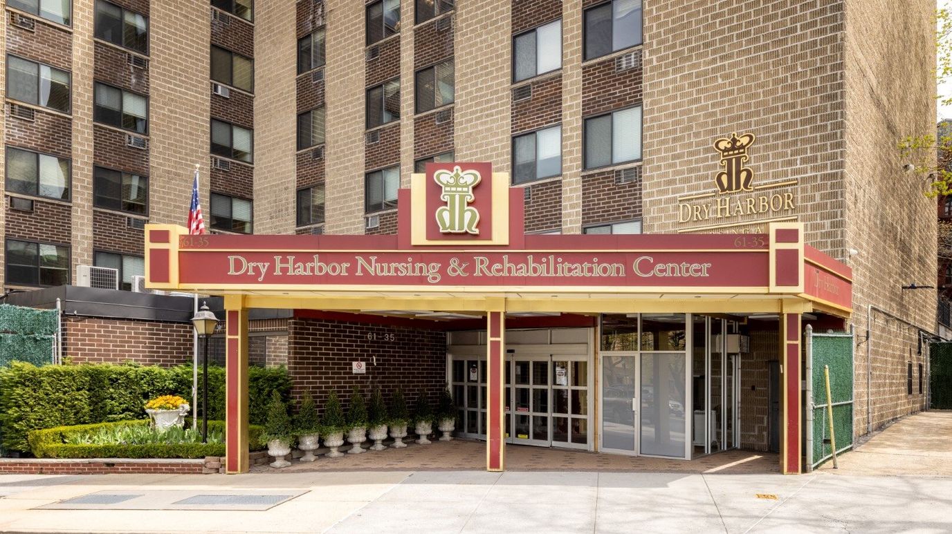 Exterior view of Dry Harbor Nursing & Rehabilitation Center entrance