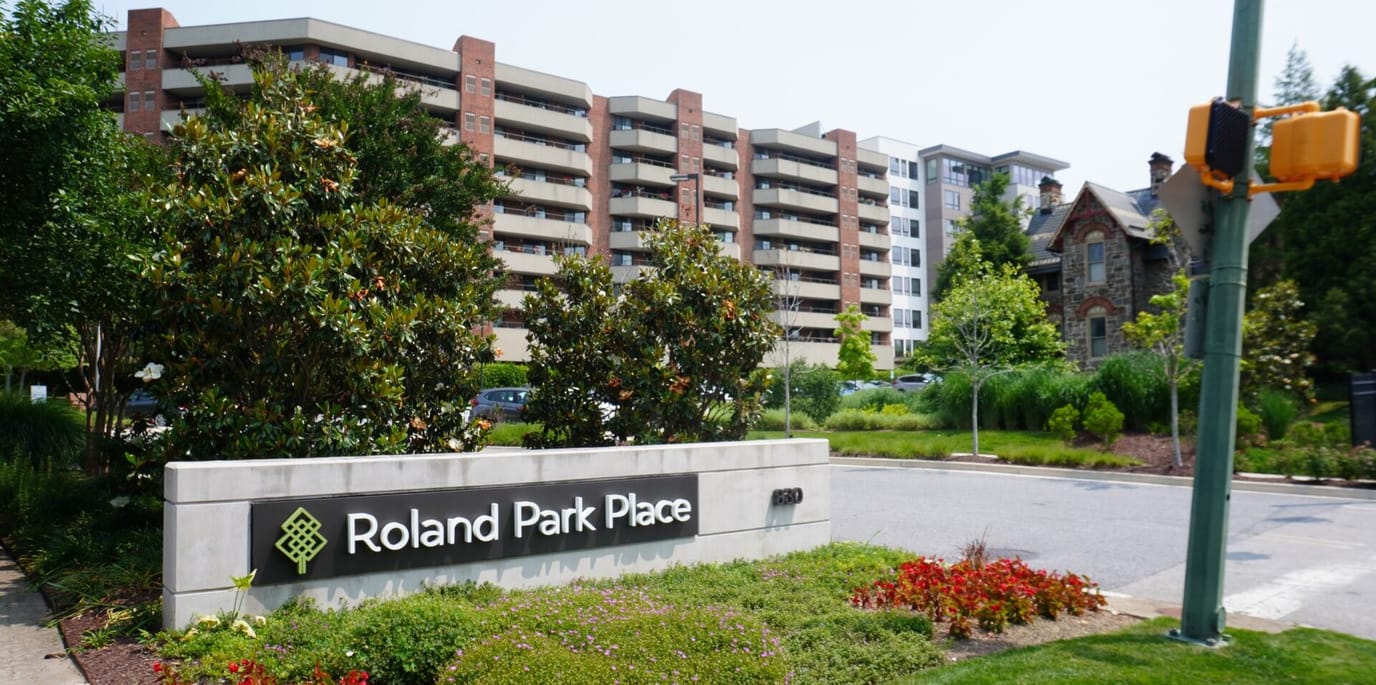 Exterior view of Roland Park Place with landscaping