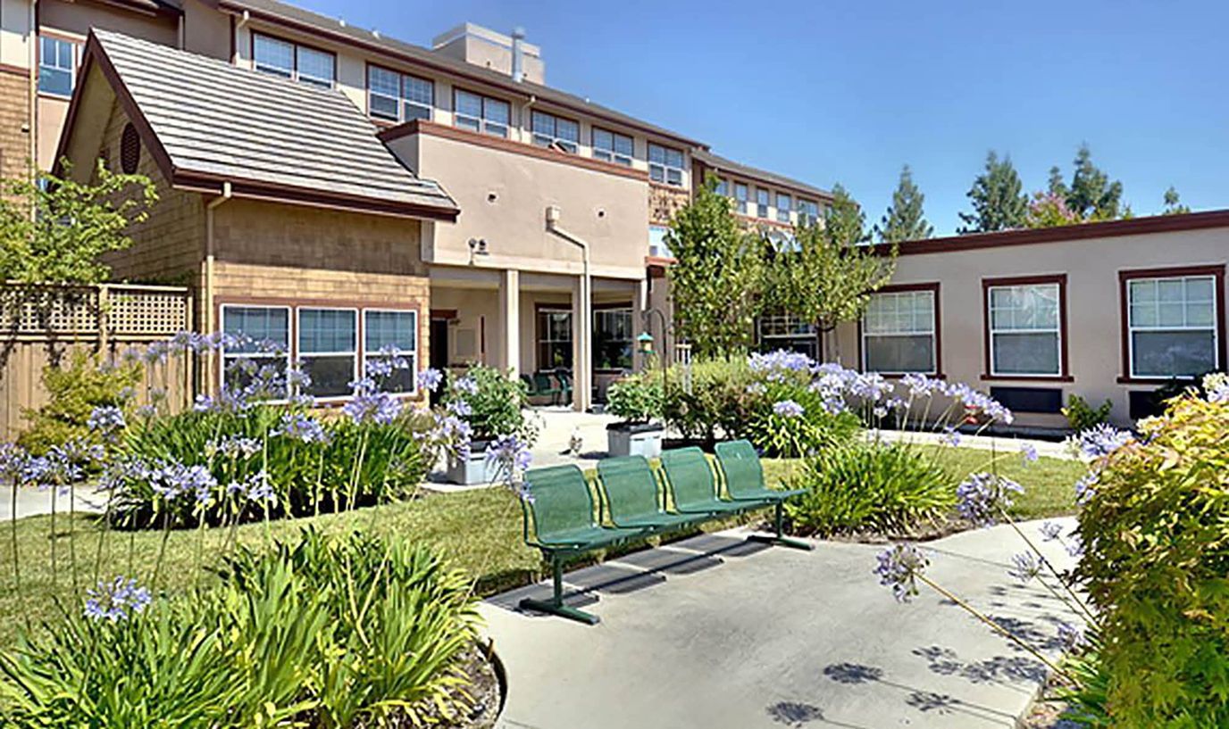 Garden area with benches and flowers at the facility