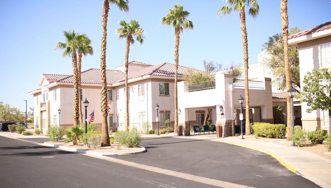 Exterior view of Heritage Springs facility with palm trees