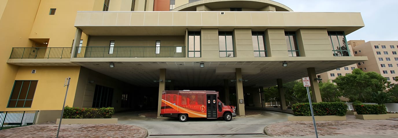 Exterior view of entrance with facility transport van
