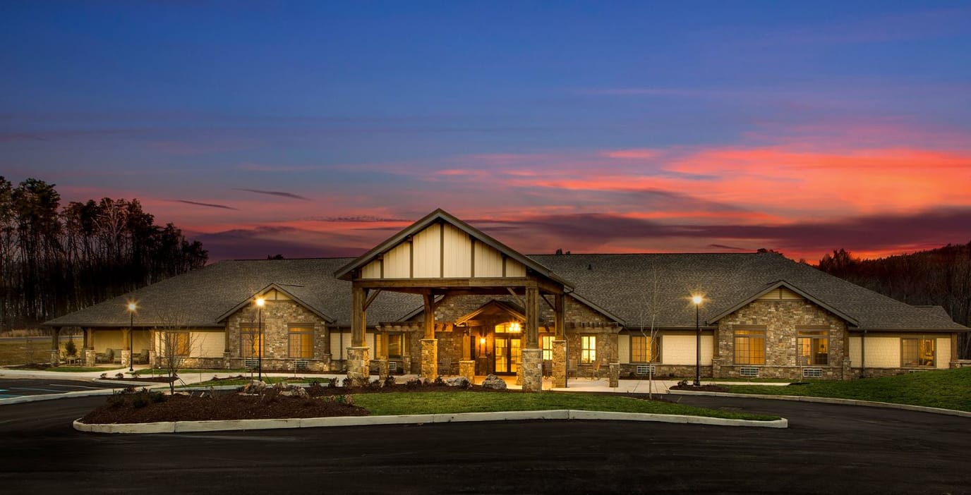 Exterior view of a senior living facility at sunset