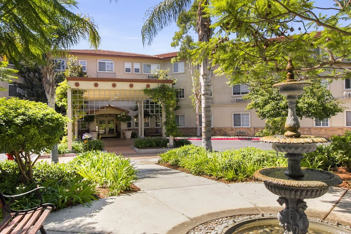 A sunny entrance with landscaping at Truewood by Merrill, Oceanside