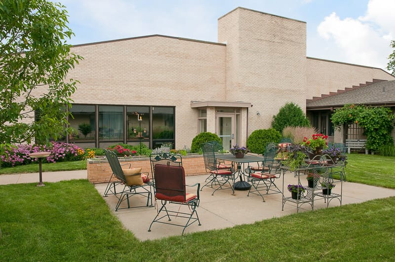 Outdoor patio area with seating and flowers.