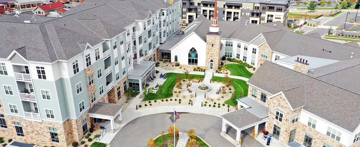 Aerial view of All Saints Assisted Living facility with landscaping