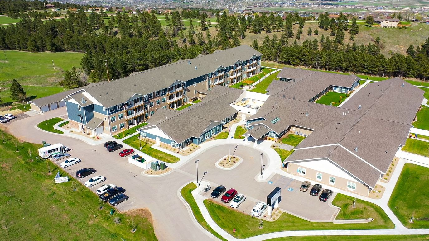 Aerial view of Peaceful Pines Senior Living facility with landscaped grounds