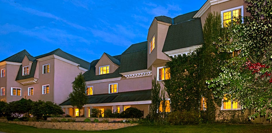 Exterior view of The Courville at Nashua at dusk