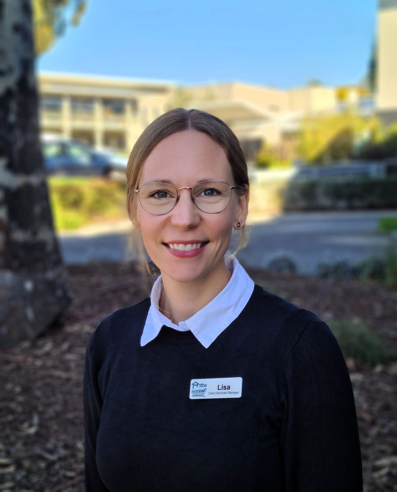 Staff member smiling in outdoor area