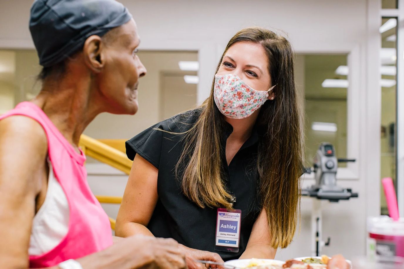Staff member engaging with a resident during meal time