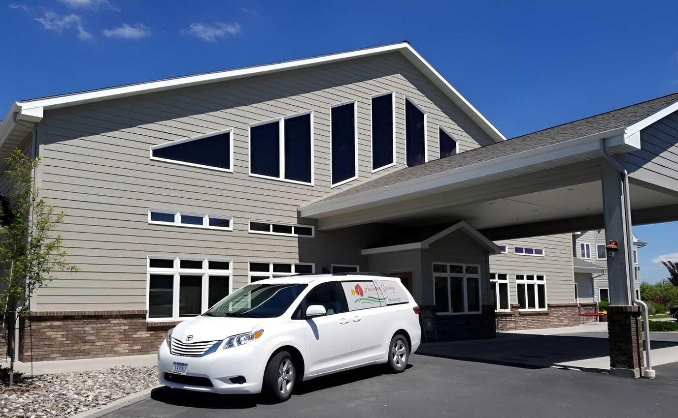 Exterior view of Autumn Springs Assisted Living with facility vehicle