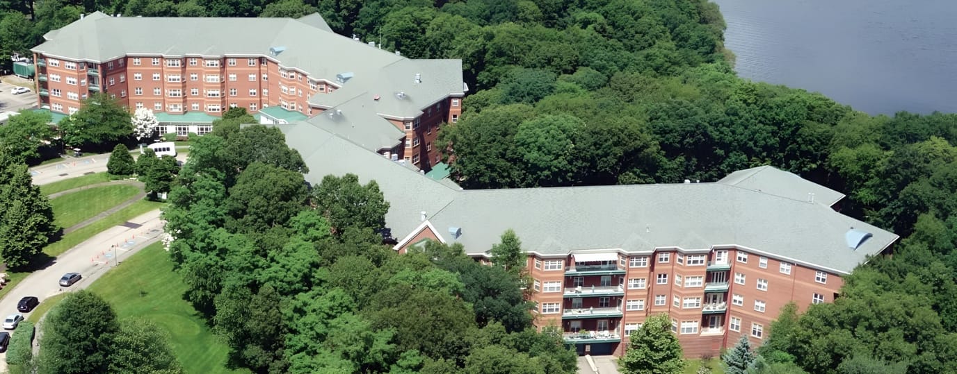 Aerial view of a senior living facility amidst greenery