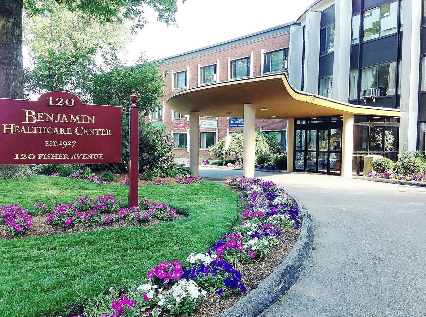 Exterior view of the Benjamin Healthcare Center with flowers