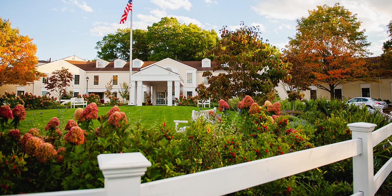 Exterior view of Essex Meadows with gardens and flowers
