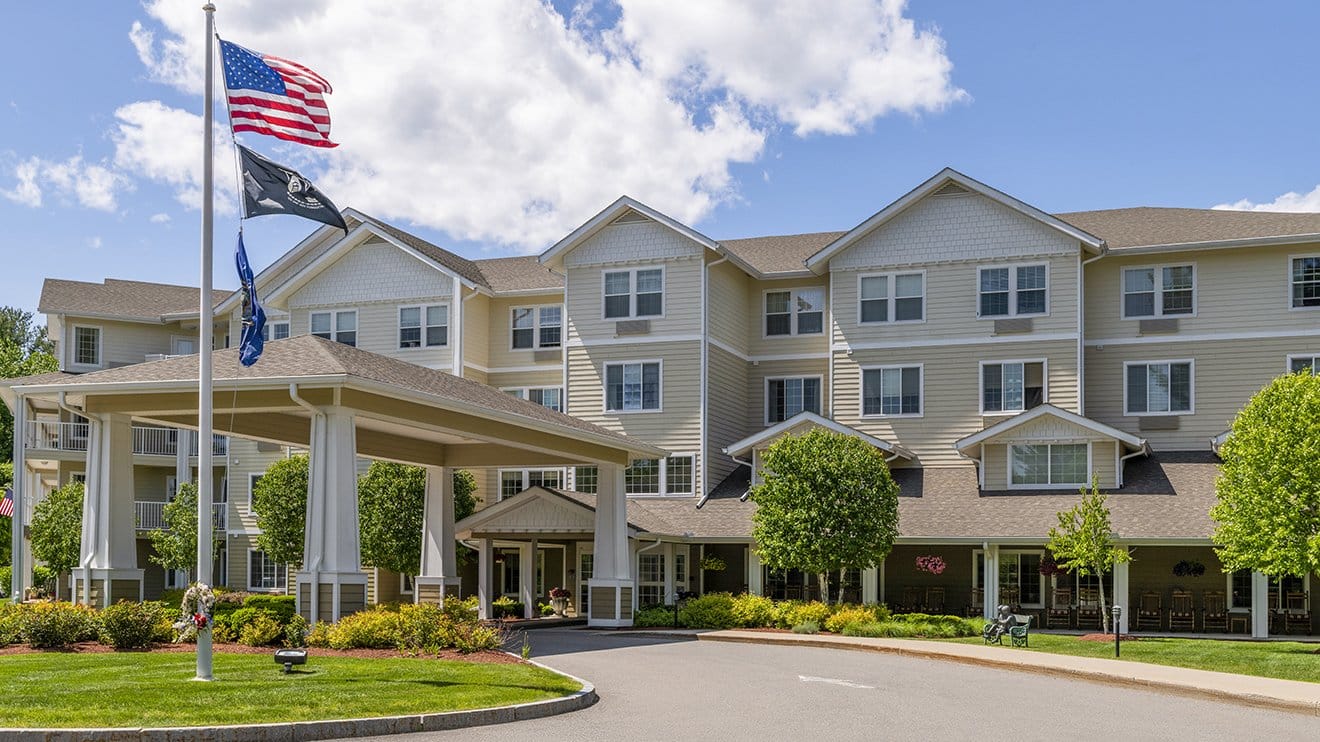 Exterior view of Holiday Birch Heights with flags