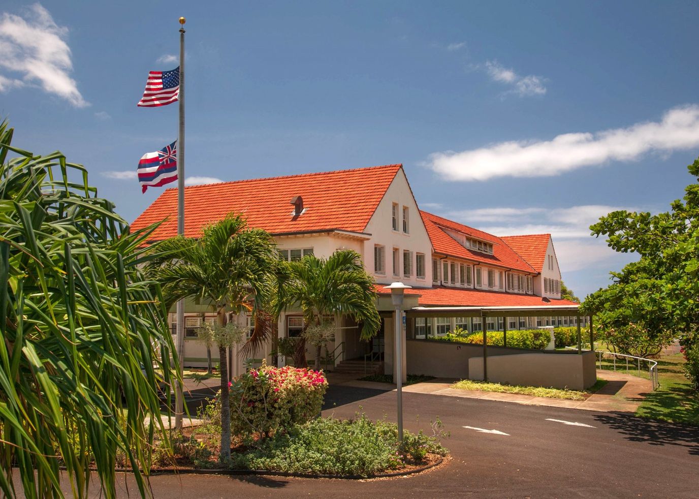 Exterior view of Lunalilo Home with flags and landscaping