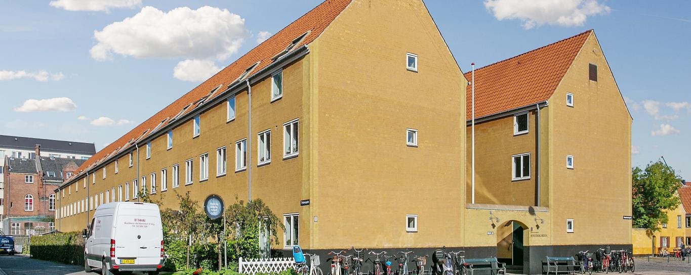 Exterior view of a senior living facility with bikes in front