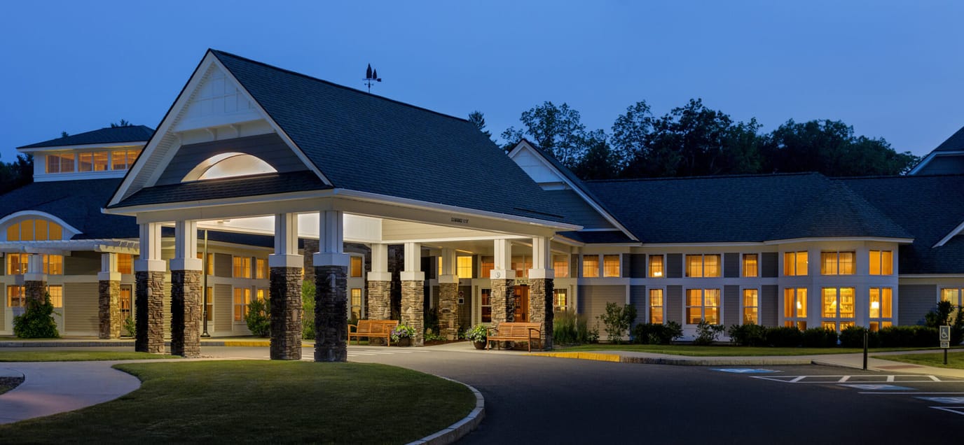 Entrance of The Boulders at dusk with illuminated windows