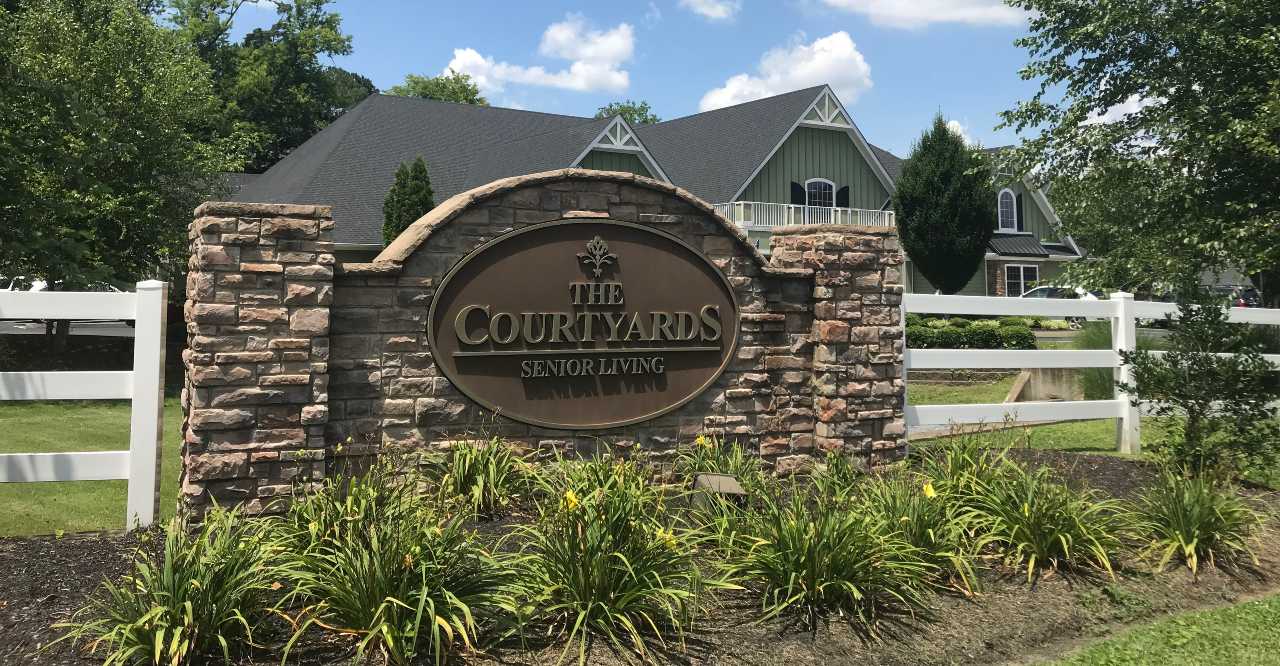 Sign for The Courtyards Senior Living facility outdoors