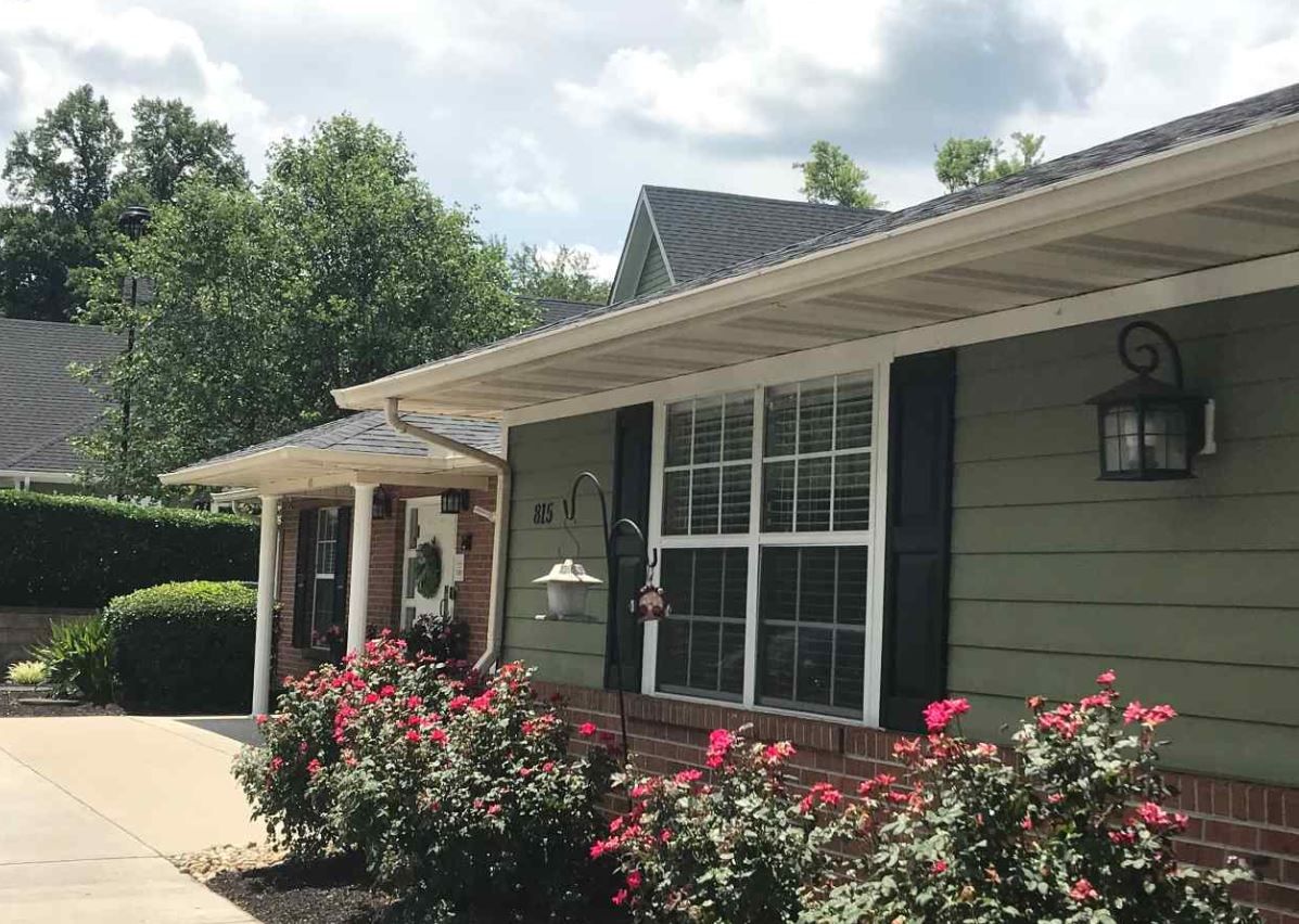Exterior view of a senior living facility with flowers