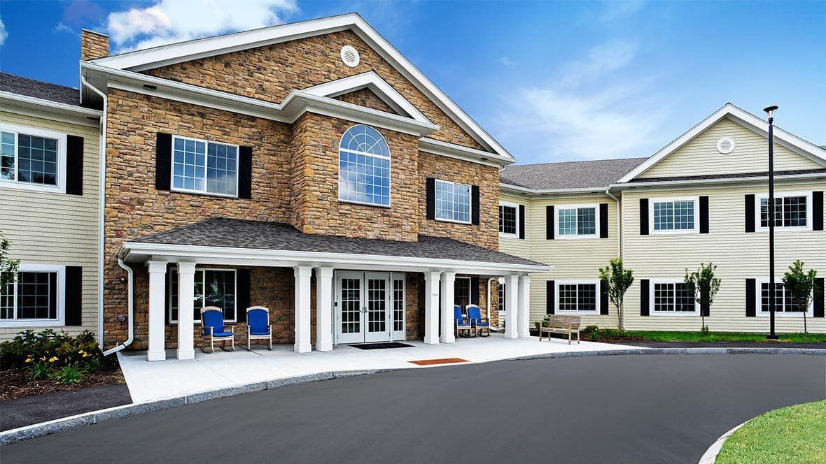 Exterior view of a senior living facility with landscaped entrance
