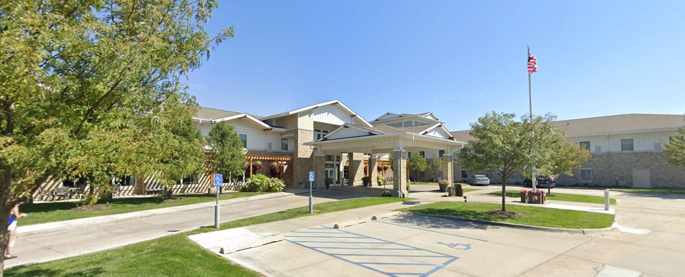 Building exterior of The Heritage at Sterling Ridge with sunny landscaping
