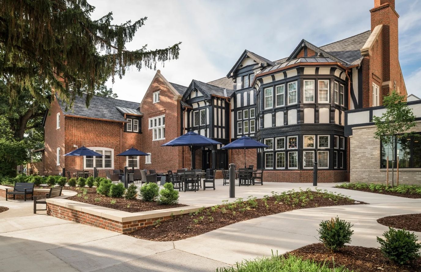 Exterior view of the assisted living facility showing outdoor seating
