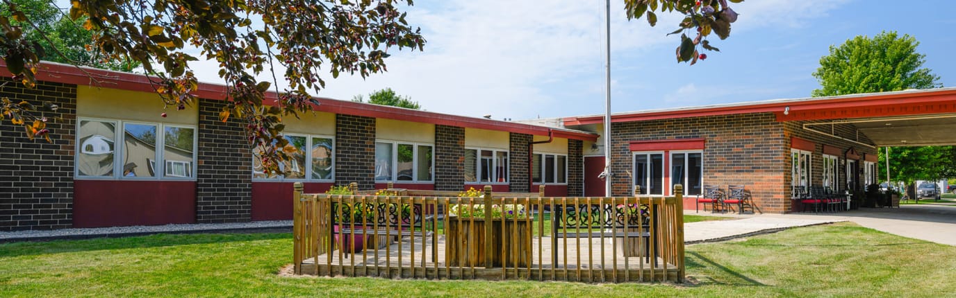 Exterior view of the facility with a small garden