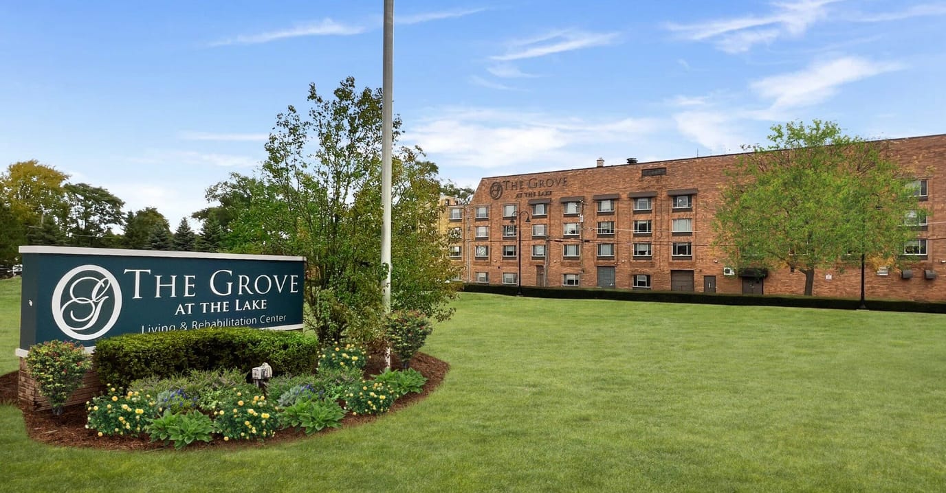 Exterior view of The Grove at the Lake facility with sign