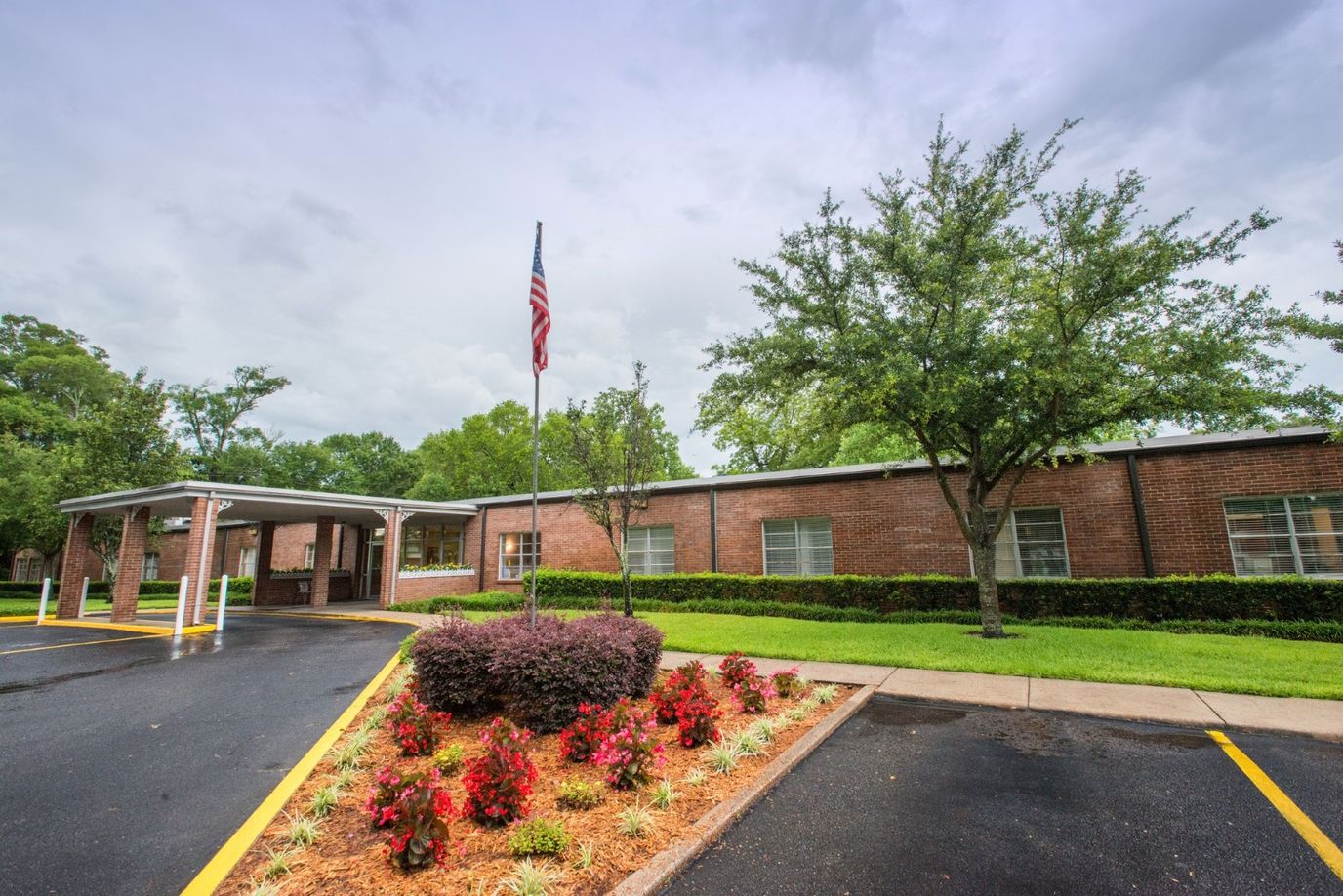 Main entrance of a senior living facility with landscaped garden