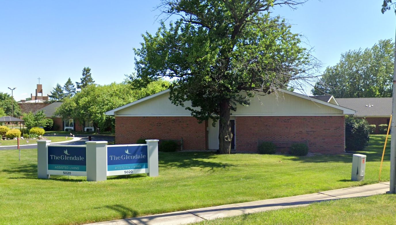 Exterior view of a senior living facility with signage