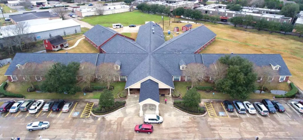 Aerial view of a senior living facility with parking area