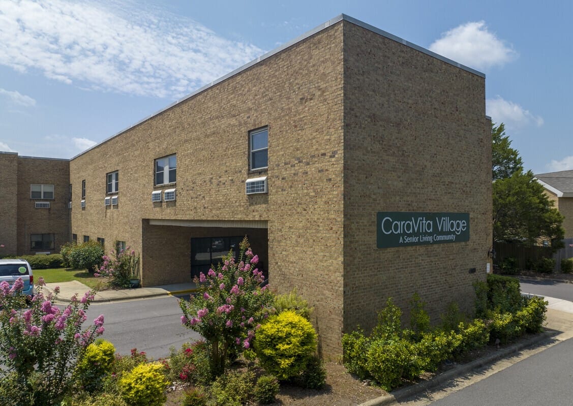 Exterior view of CaraVita Village building with landscaping