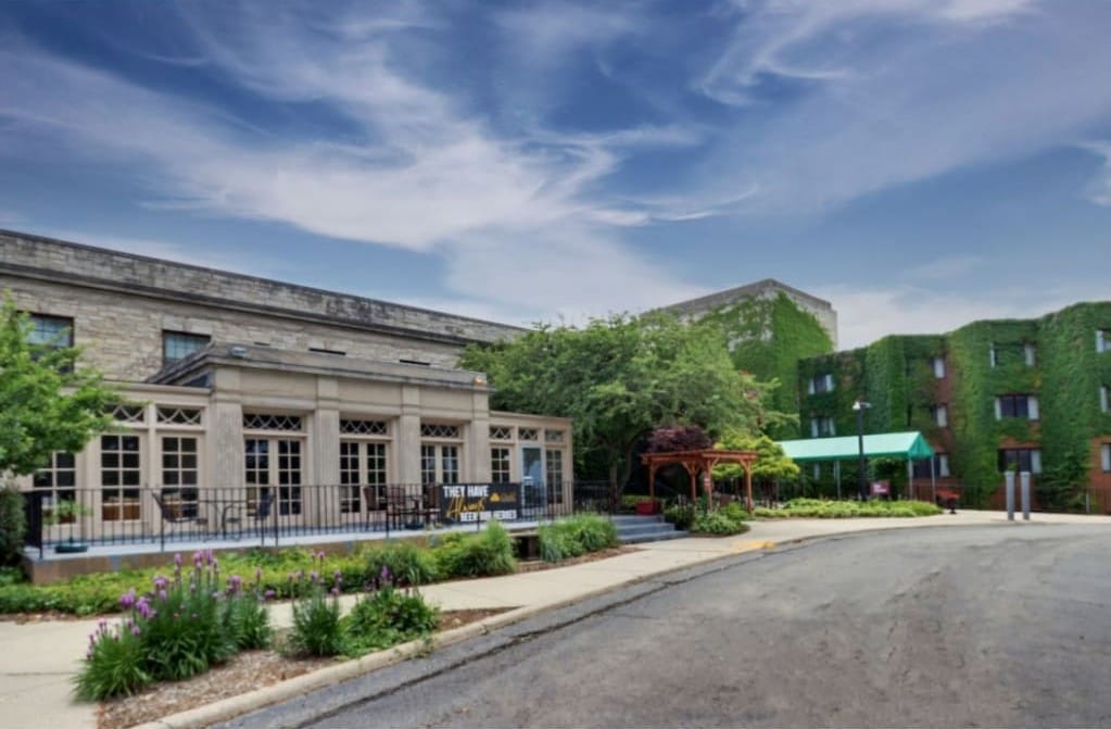 Exterior view of a nursing home facility with gardens