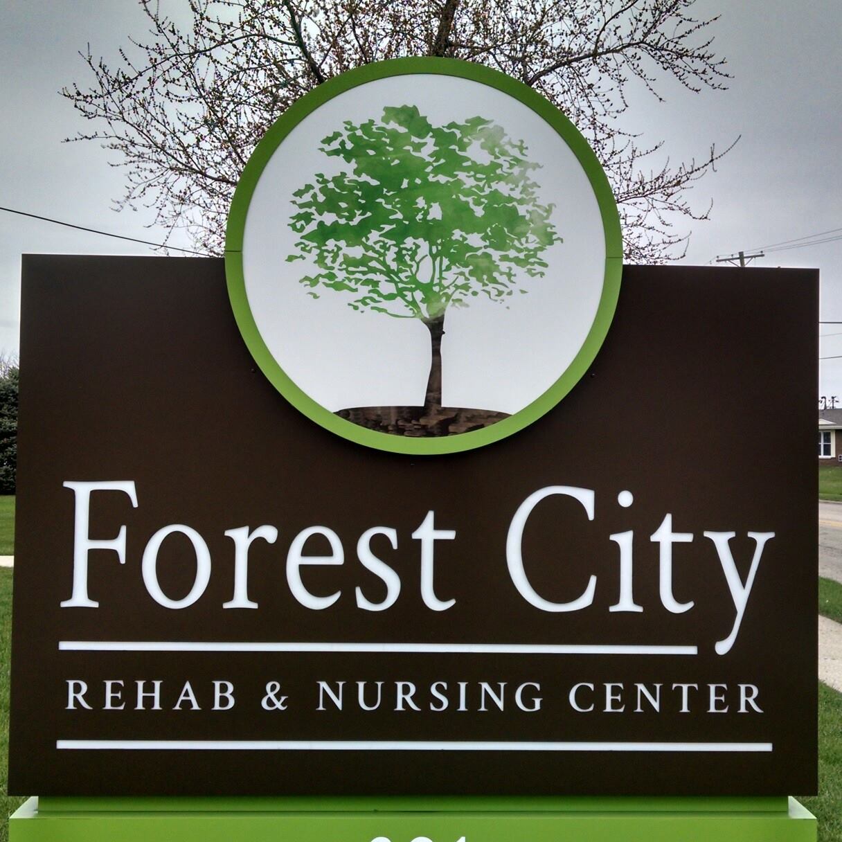 Facility logo on a sign with a tree motif