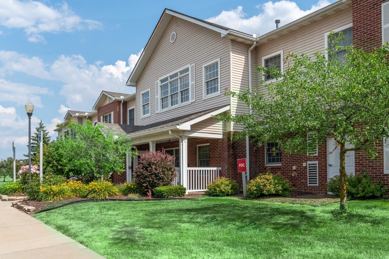Exterior view of Landings of Genesee Valley with gardens