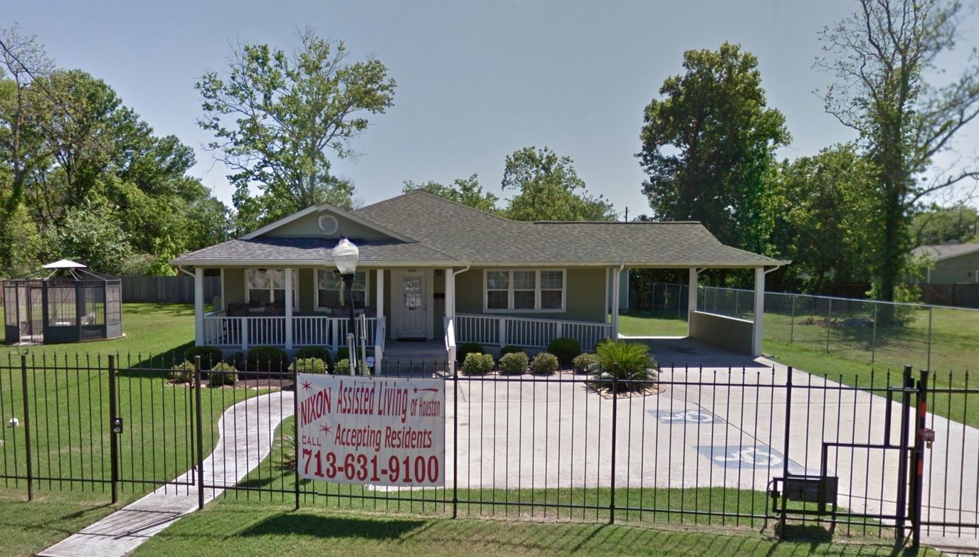 Exterior view of Nixon Assisted Living facility with a sign.