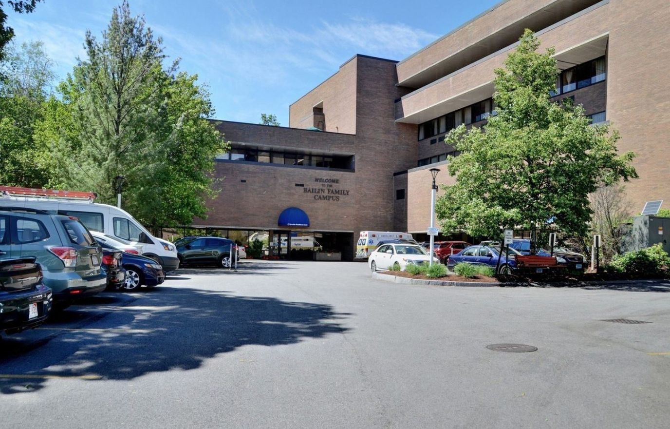 Exterior view of the facility with parked vehicles