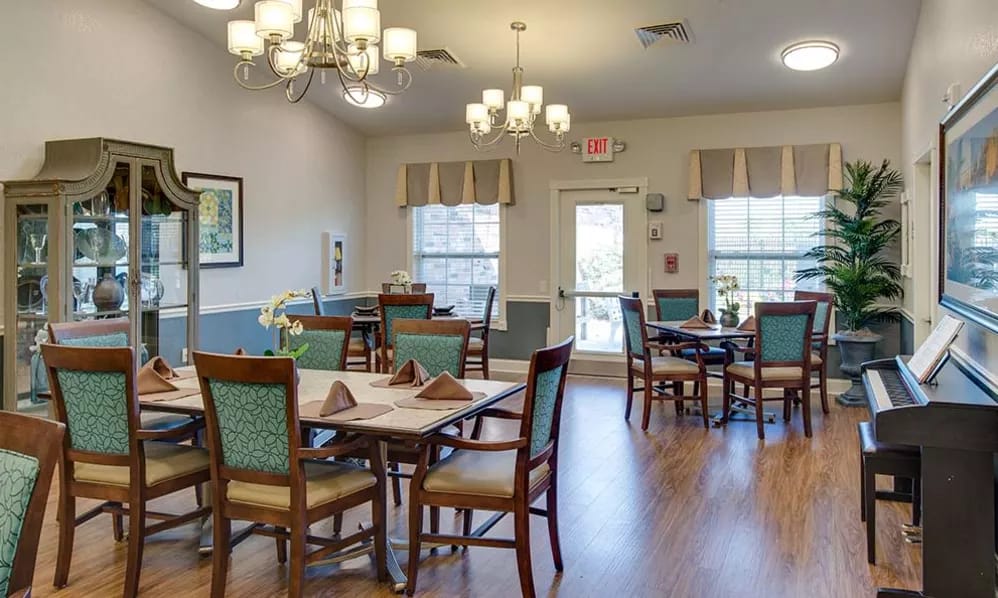 Bright dining room with tables set for a meal