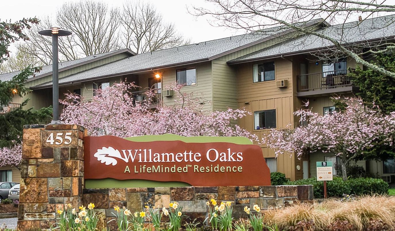 Exterior view of Willamette Oaks with blooming trees