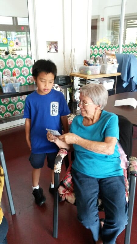 Aged to Perfection, assisted living in Waipahu, HI — Child and senior woman sharing a conversation