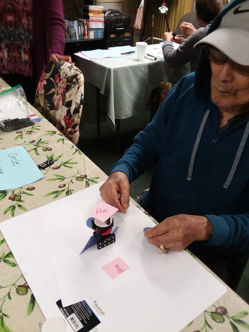 Resident engaged in an activity with craft materials.