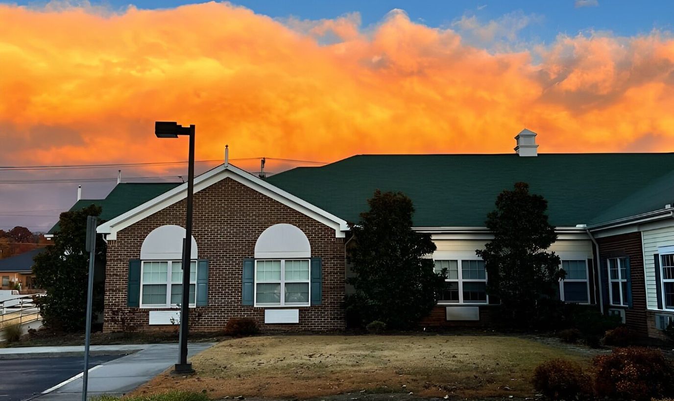 Exterior view of a senior living facility at sunset