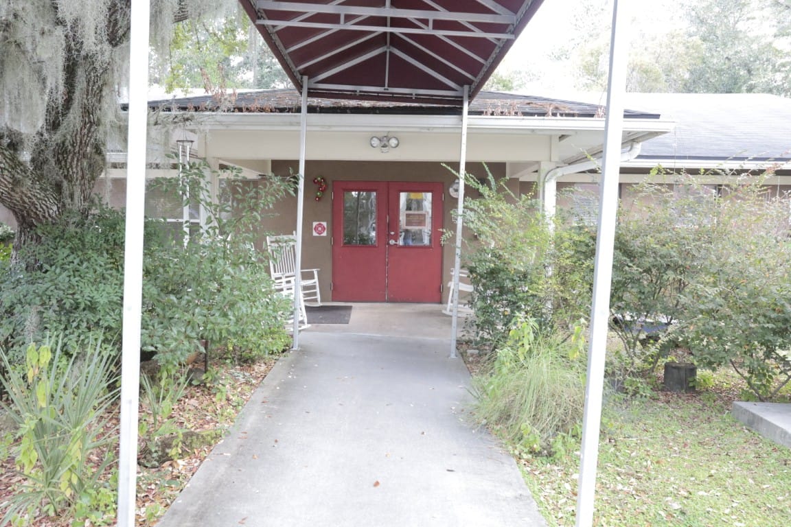 Entrance to a senior living facility with rocking chairs