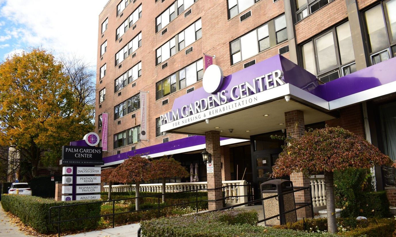 Exterior view of Palm Gardens Center with signage